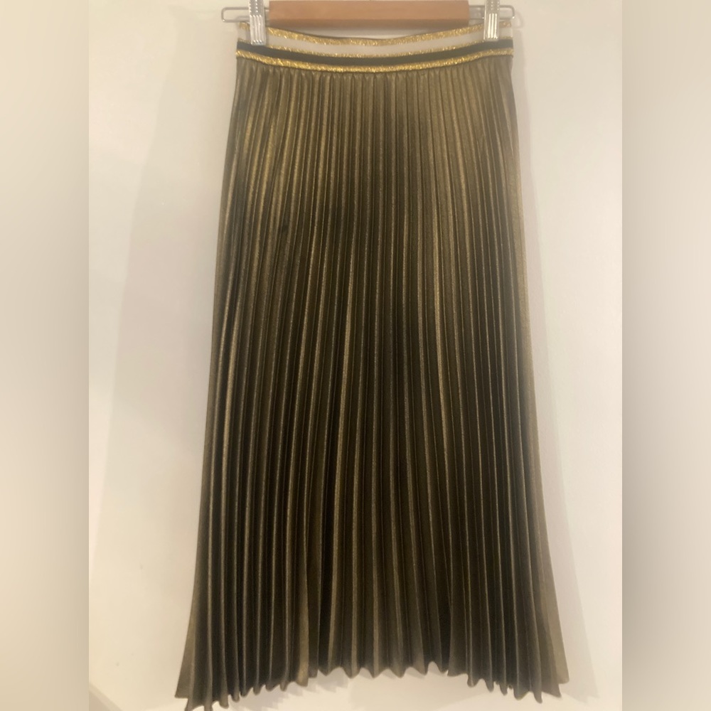 Marks and Spencer’s gold pleated skirt.